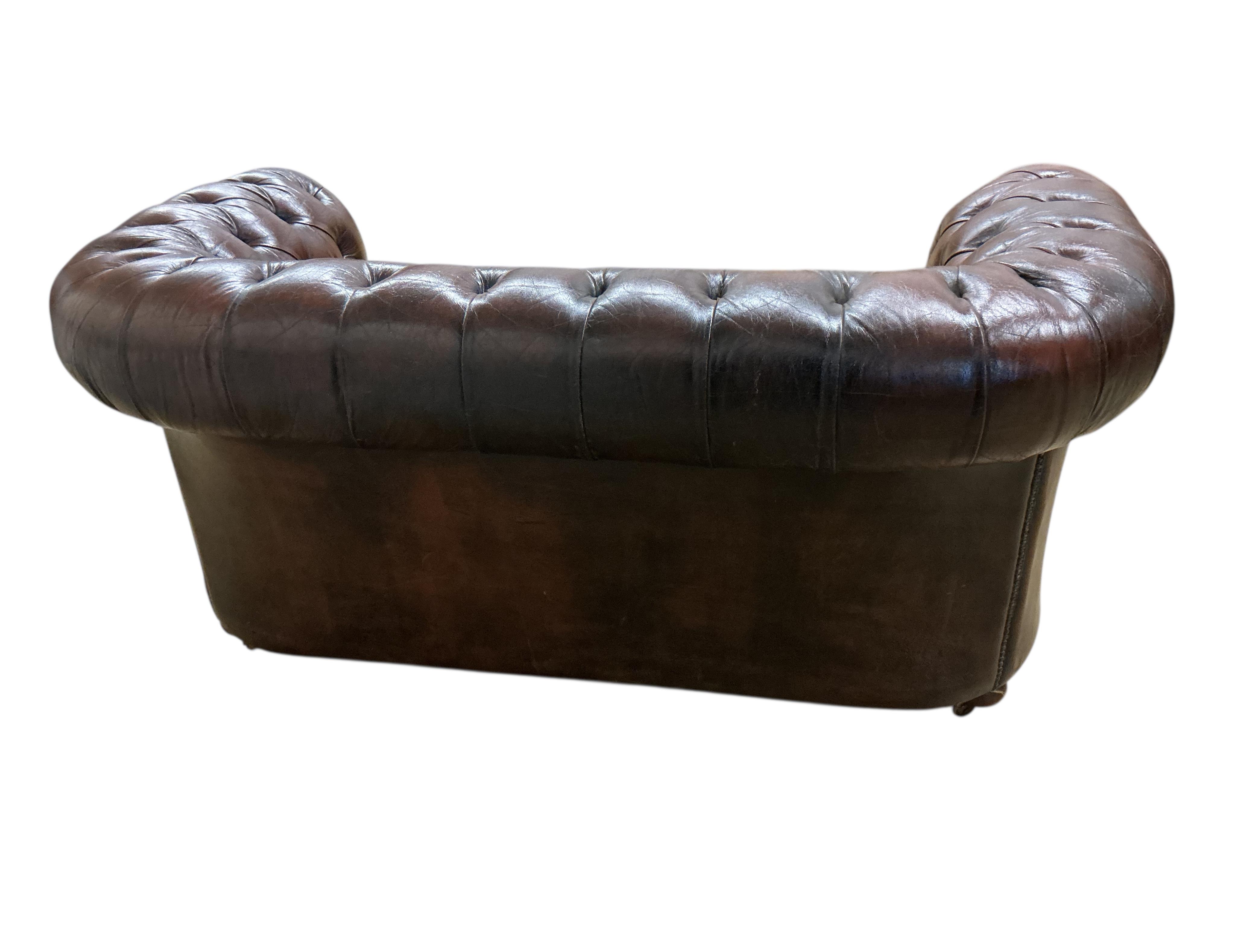 A Victorian style buttoned brown leather Chesterfield settee, width 170cm, depth 84cm, height 76cm